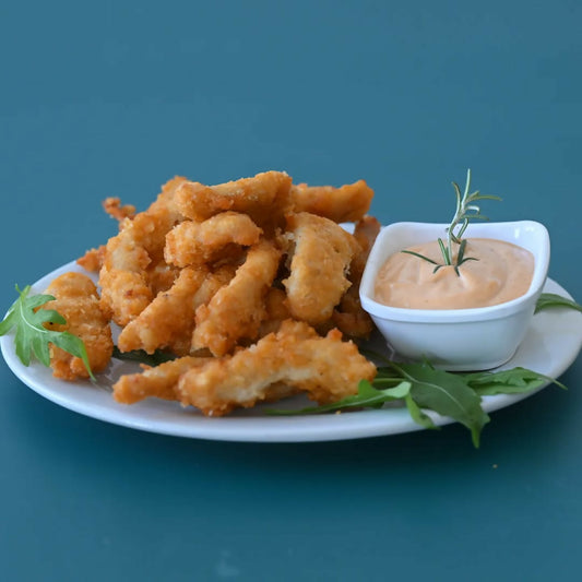 'Golden, crispy chicken strips served with a fiery dynamite sauce – the perfect kick to start your meal!'#chicken #mouthwatering #delicious #foodie
